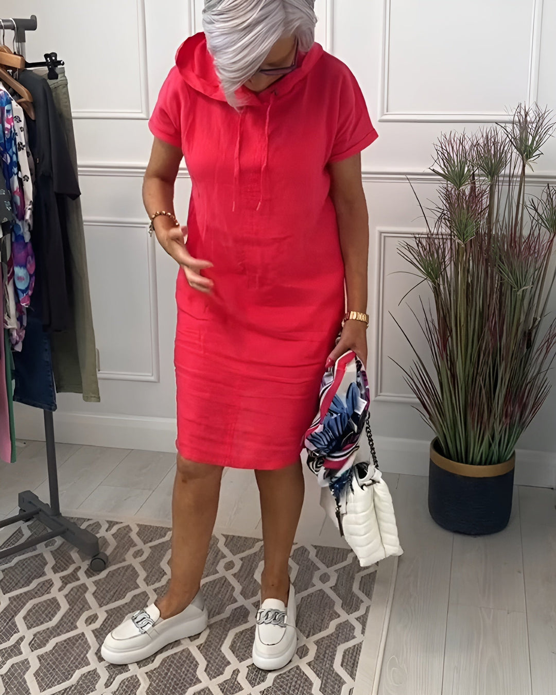 Stylish women's relaxed fit midi dress with an adjustable hood, ideal for casual outfits.