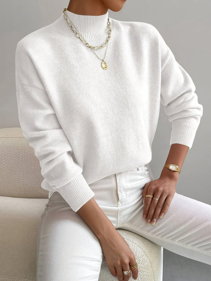 Chic women's long sleeve mock turtleneck sweater with a relaxed fit. Ideal for comfortable office or casual wear.