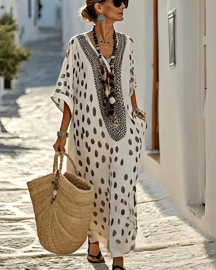 Women's chic polka dot maxi kaftan dress with a relaxed fit, great for vacation & stylish summer look.