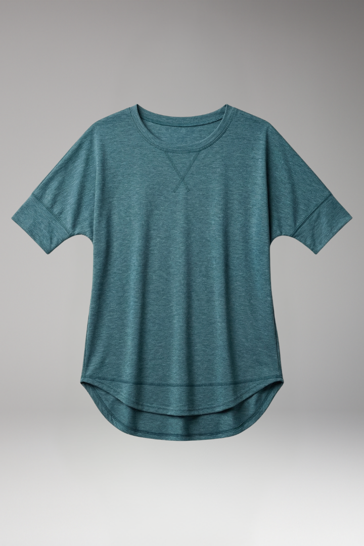 Model wears a comfortable women's relaxed fit t-shirt, round neck, short sleeve, and curved hem top.