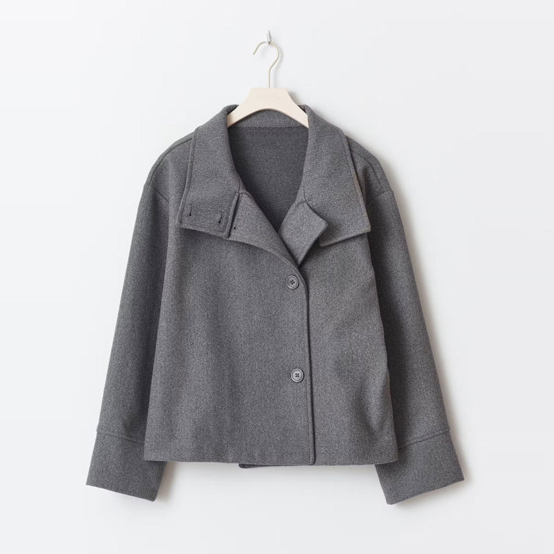Stylish women's short coat: relaxed fit, prominent button closure, cozy high neckline. Winter fashion essential.