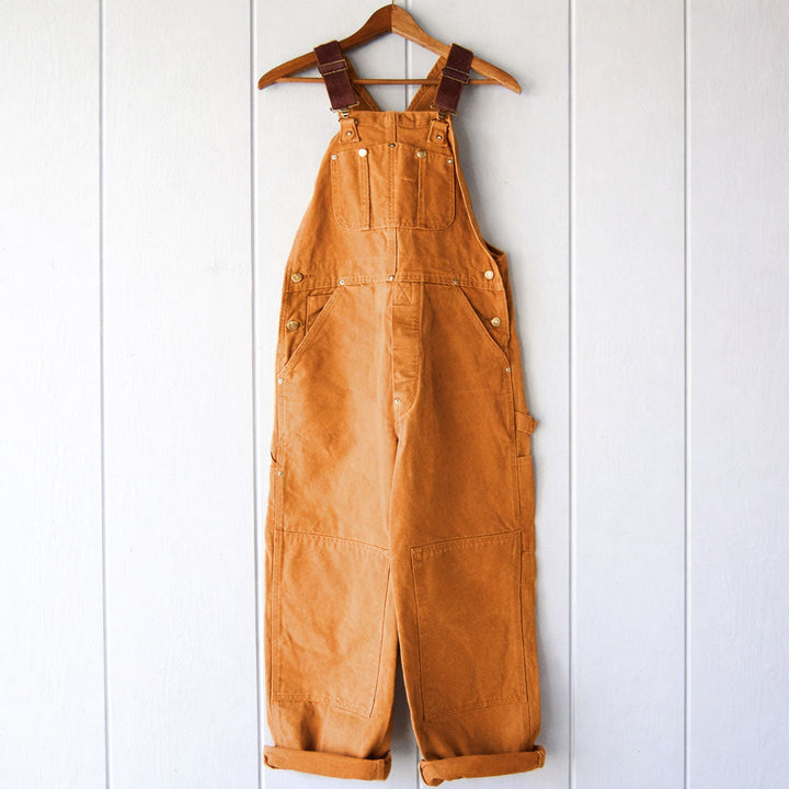 Women's relaxed fit sleeveless overalls with adjustable straps, perfect for casual everyday comfort and style.