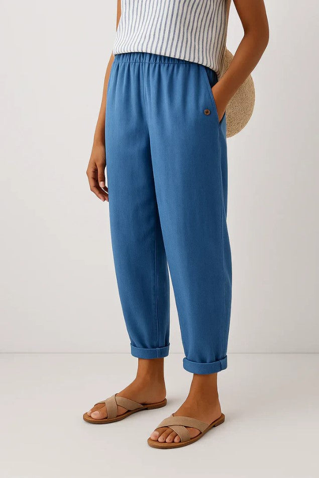 Detail of women's relaxed fit trousers showing comfortable elastic waistband & practical slip pockets.