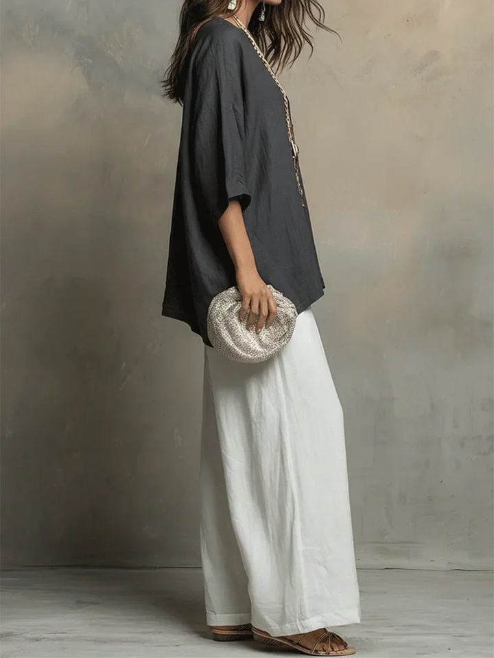 Chic women's relaxed fit two-piece shirt and wide-leg pant set. Versatile matching casual summer outfit.
