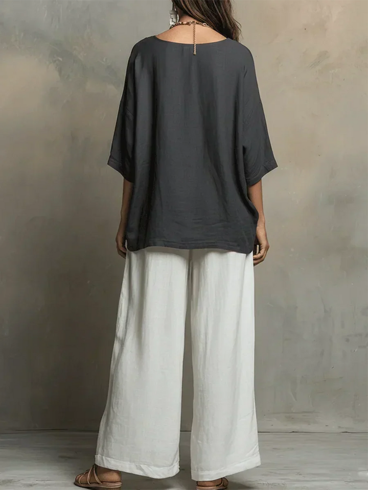 Full view of women's relaxed fit two-piece shirt & wide-leg pants matching set. Comfortable summer style.