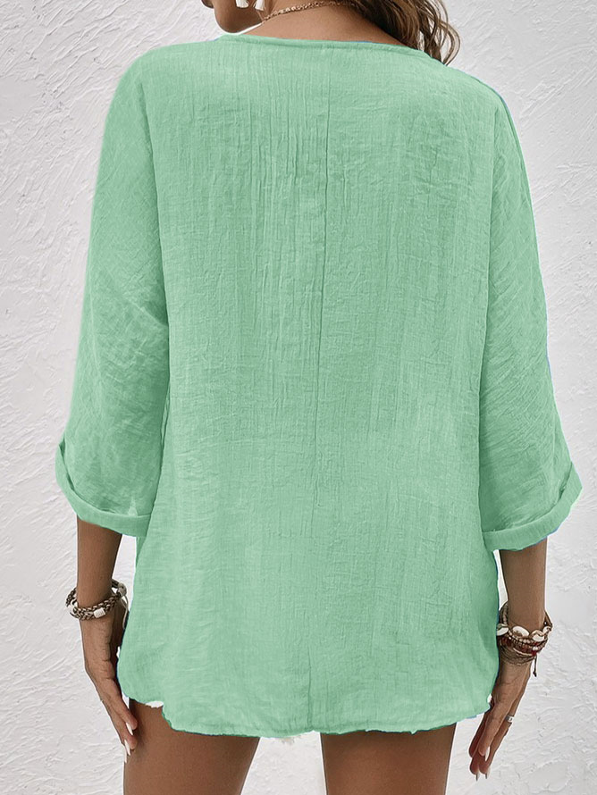 Chic V-neck button-down women's shirt with a relaxed fit, ideal as a stylish spring or summer blouse.