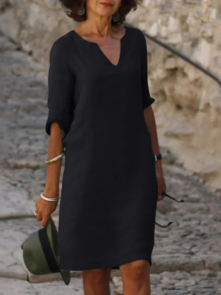 Women's relaxed fit V-neck midi dress with 3/4 sleeves. Elegant casual style, perfect for everyday wear.