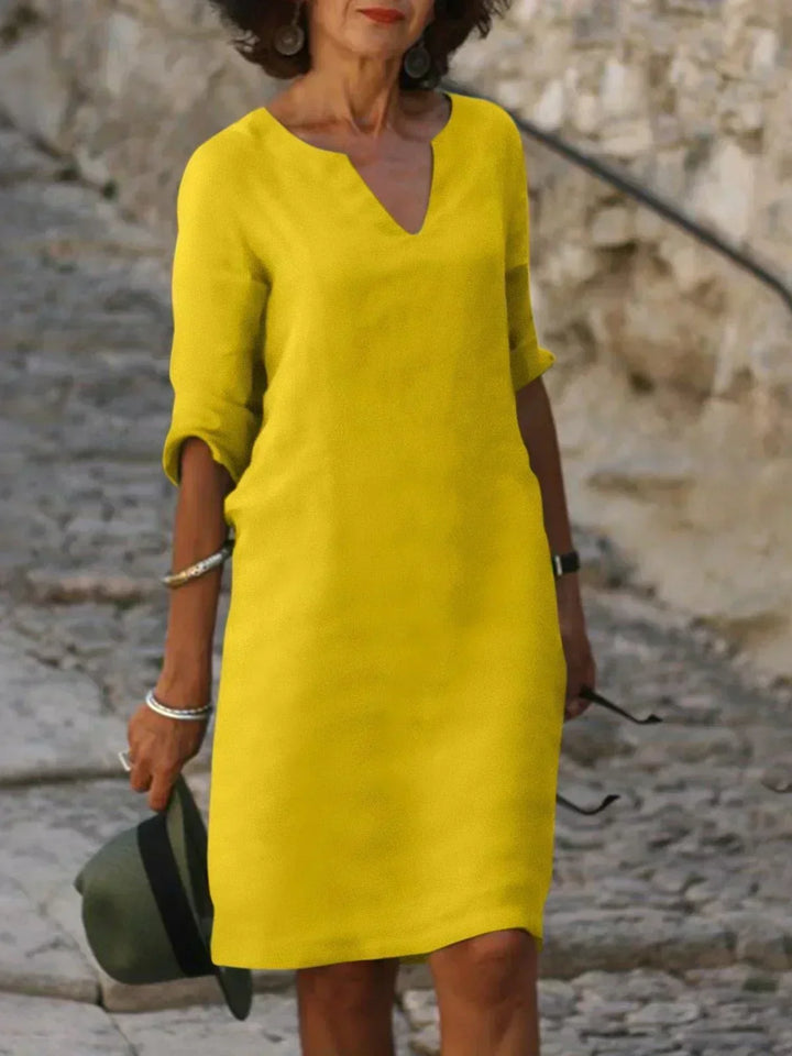 Effortlessly chic women's 3/4 sleeve V-neck midi dress. Relaxed fit design for comfortable, stylish everyday fashion.
