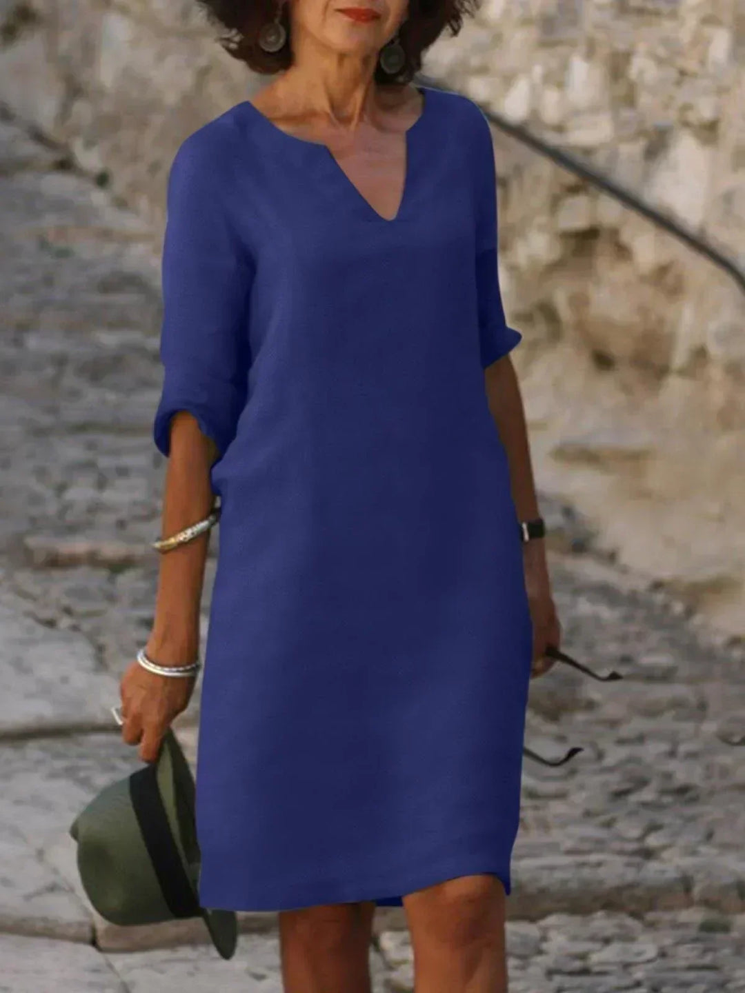 Women's elegant V-neck midi dress featuring three-quarter sleeves & relaxed fit for versatile styling.