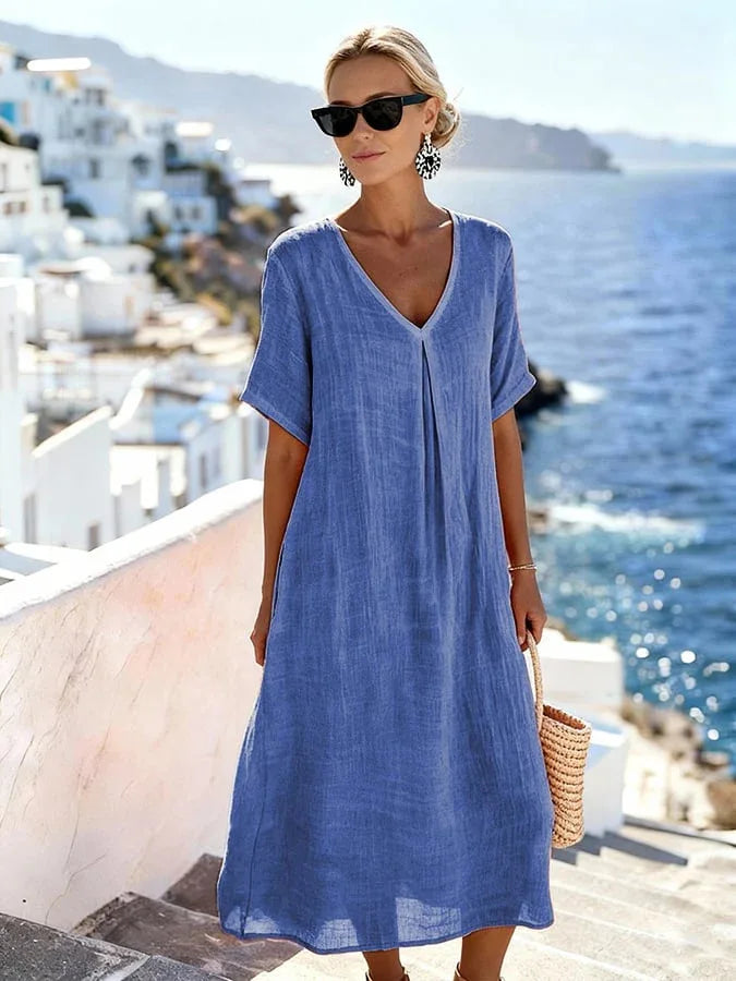 Stylish women's relaxed V-neck midi dress with short sleeves, ideal beach or vacation attire.