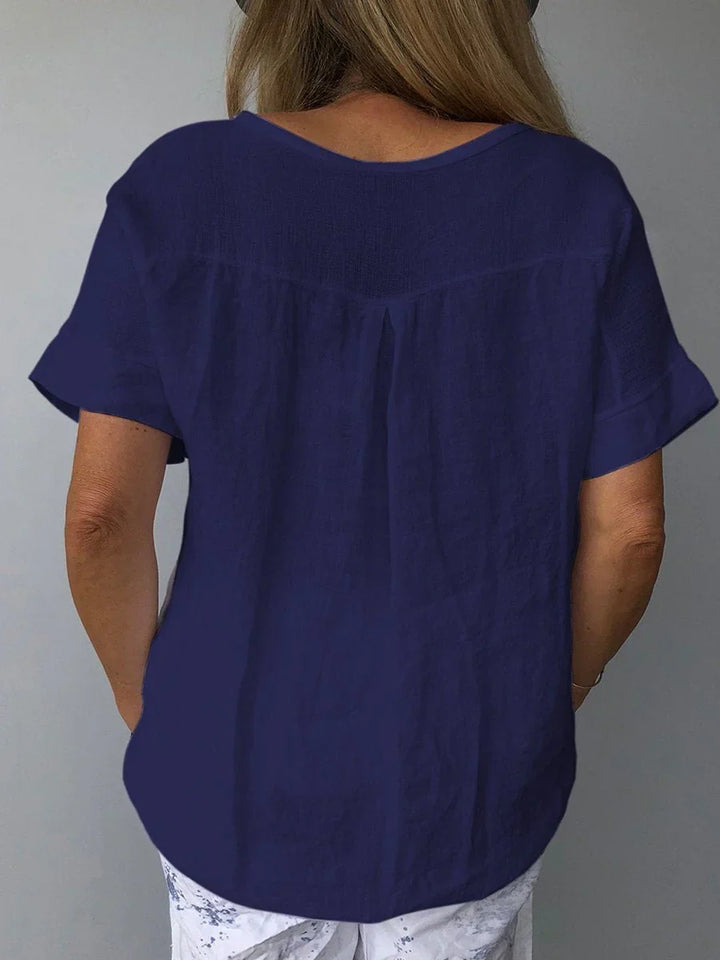 Stylish women's V-neck short sleeve blouse with a relaxed fit for comfortable daily wear or vacation.