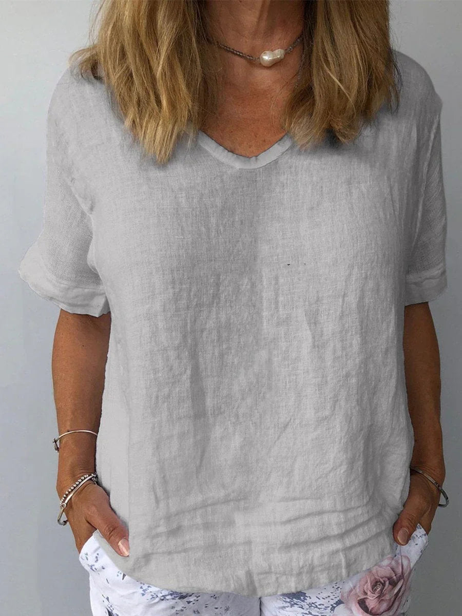 Casual women's short sleeve blouse featuring a comfortable relaxed fit and flattering V-neck design.