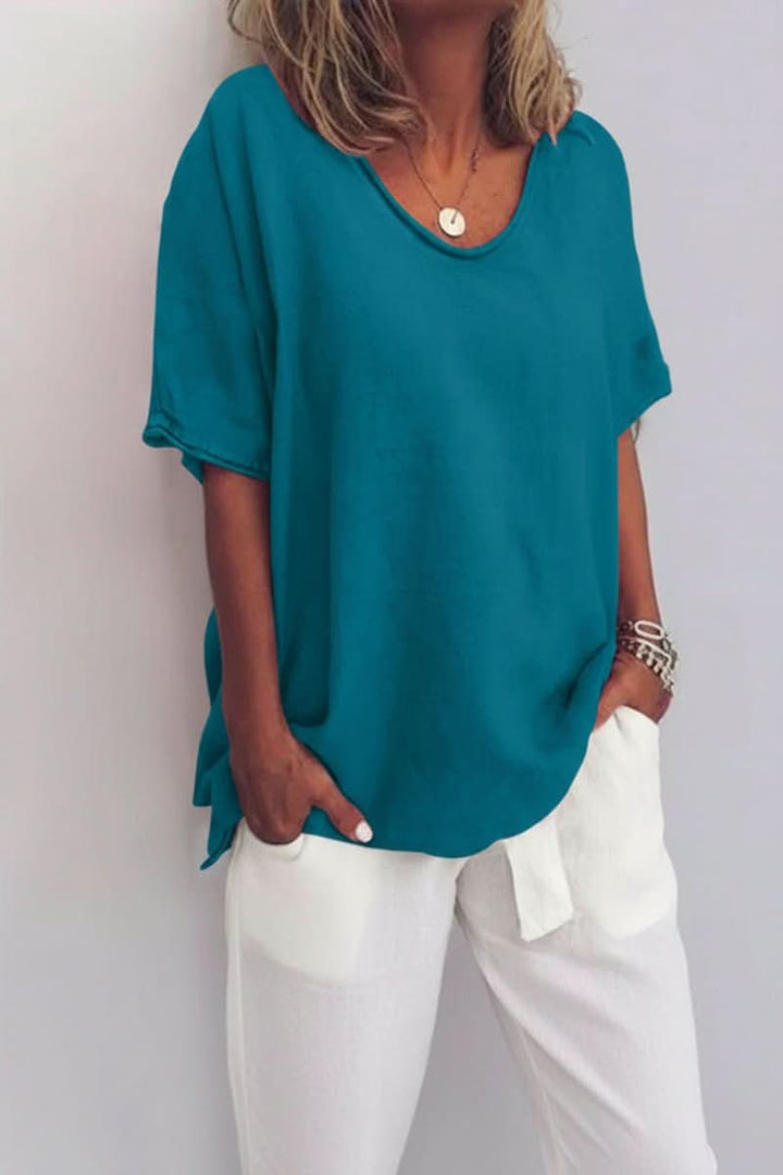 Elegant yet casual women's V-neck summer blouse, flowy relaxed fit for warm days.