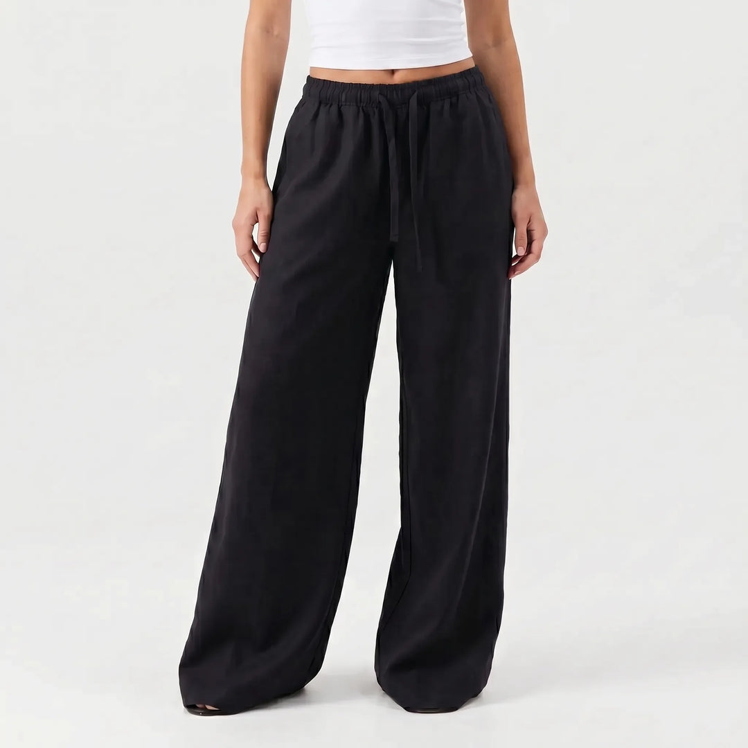 White women's wide-leg pants, relaxed fit with a drawstring waist, perfect for warm weather comfort.