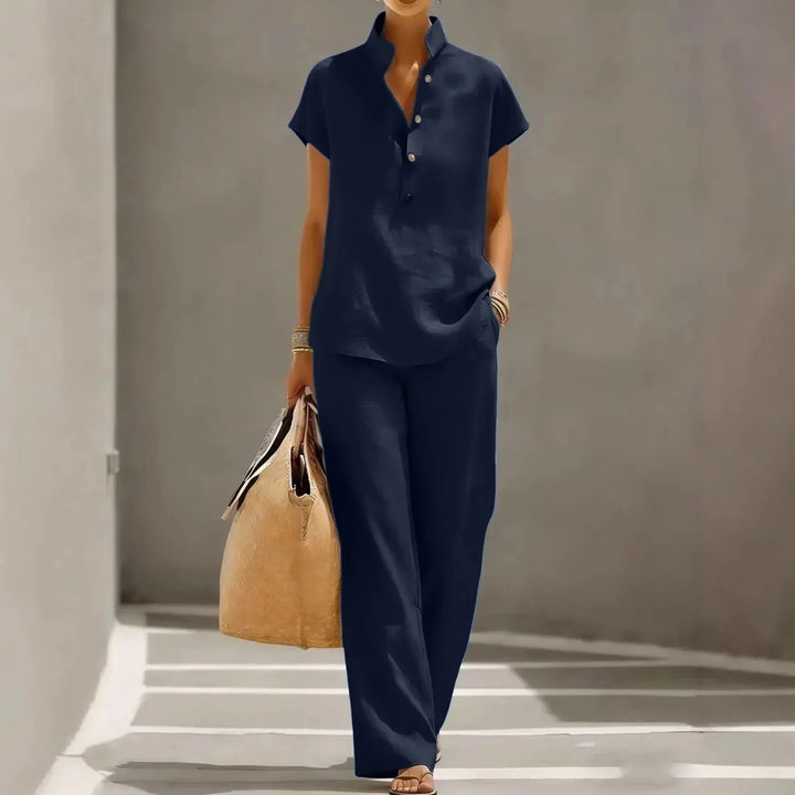 Women's relaxed two-piece summer outfit with wide-leg pants and short-sleeve top. Comfortable casual resort wear.
