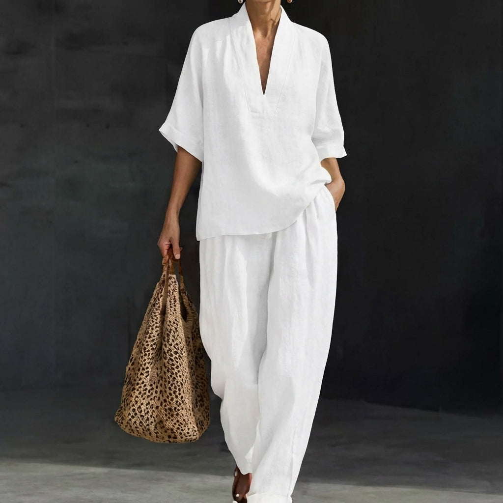 Chic women's matching set featuring a relaxed V-neck top & wide-leg pants. Ideal for travel & casual fashion.