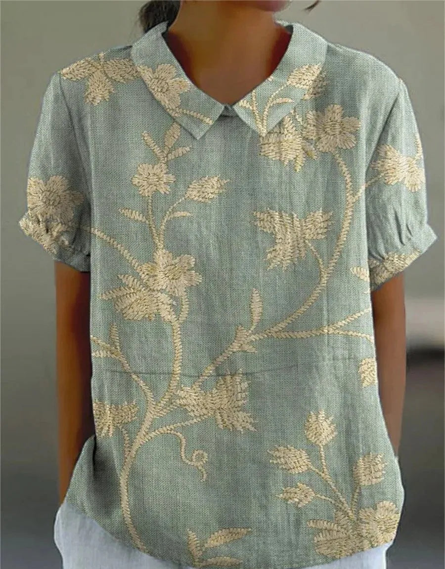 Women's retro floral embroidered short-sleeve top, vintage-inspired for summer fashion.