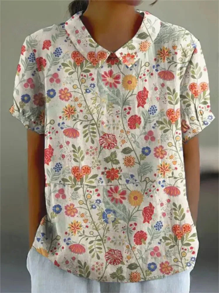 Vibrant retro floral embroidered women's short-sleeve top, vintage style, perfect for summer.