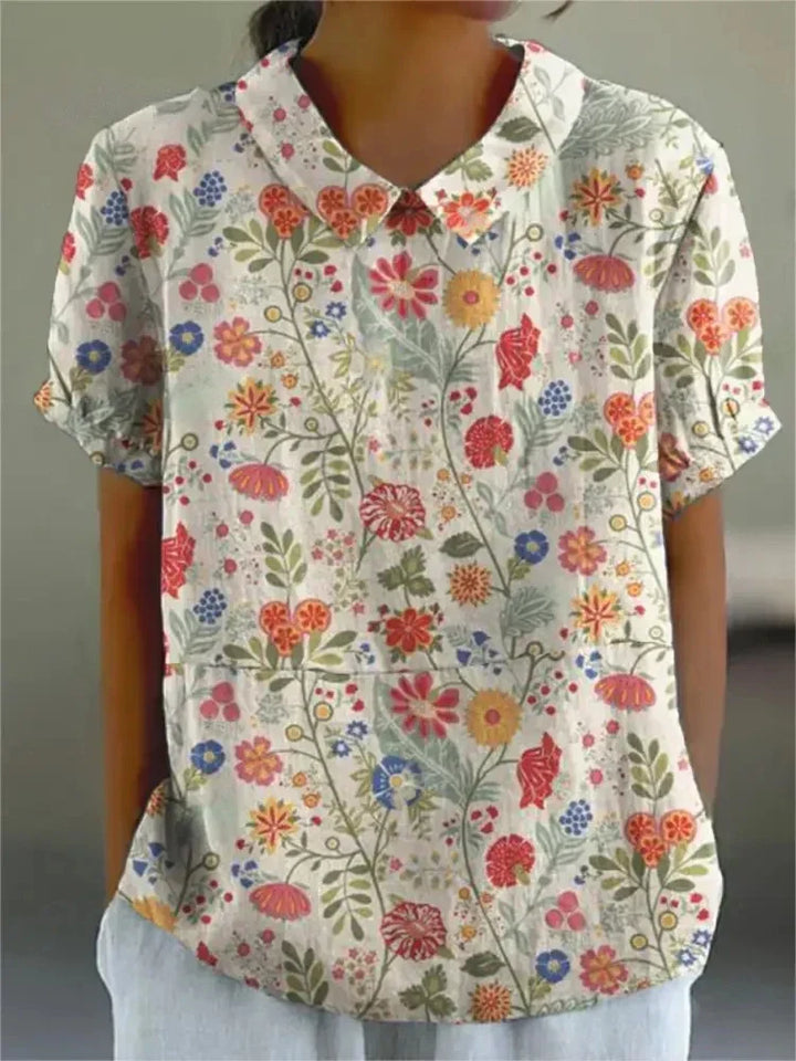 Vibrant retro floral embroidered women's short-sleeve top, vintage style, perfect for summer.