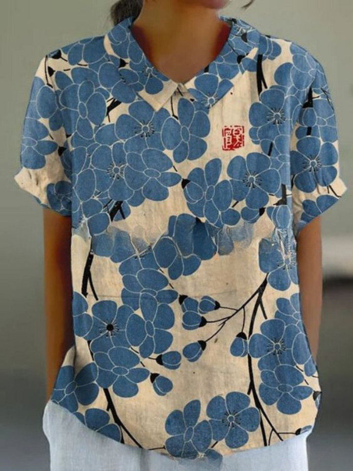 Elegant women's retro short-sleeve top with vibrant floral embroidery, a stylish summer blouse.