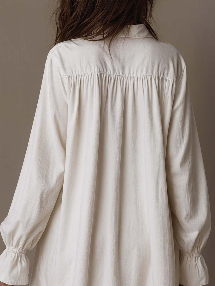 Stylish white retro mini dress for women, featuring long sleeves & an irregular hem. Ideal for casual or party looks.