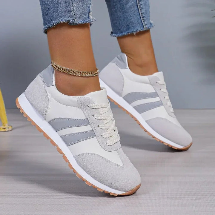 Colourblock women's sneakers featuring retro stripes and classic lace-up design, ideal for versatile street style.