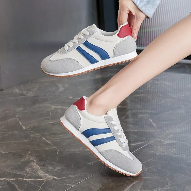 Athletic-inspired women's retro colourblock lace-up sneakers with striped details for comfortable everyday style.