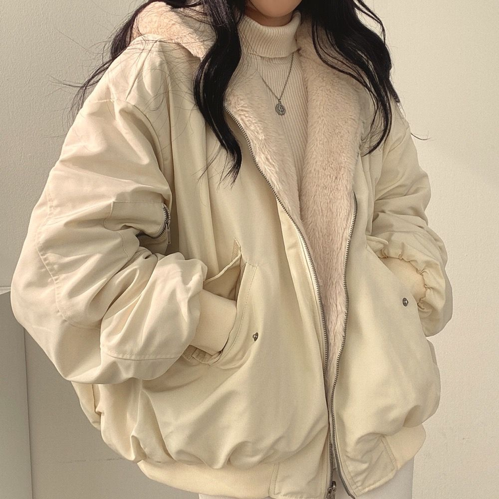 Detail of reversible fabric on women's hooded jacket, perfect for versatile fashion & cozy warmth.
