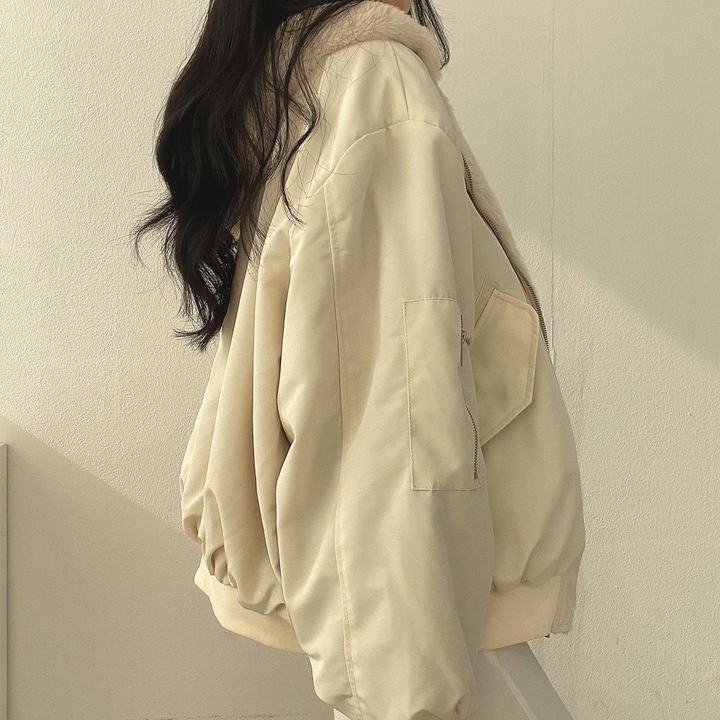 Back view of a women's reversible hooded jacket, featuring comfortable design & versatility.