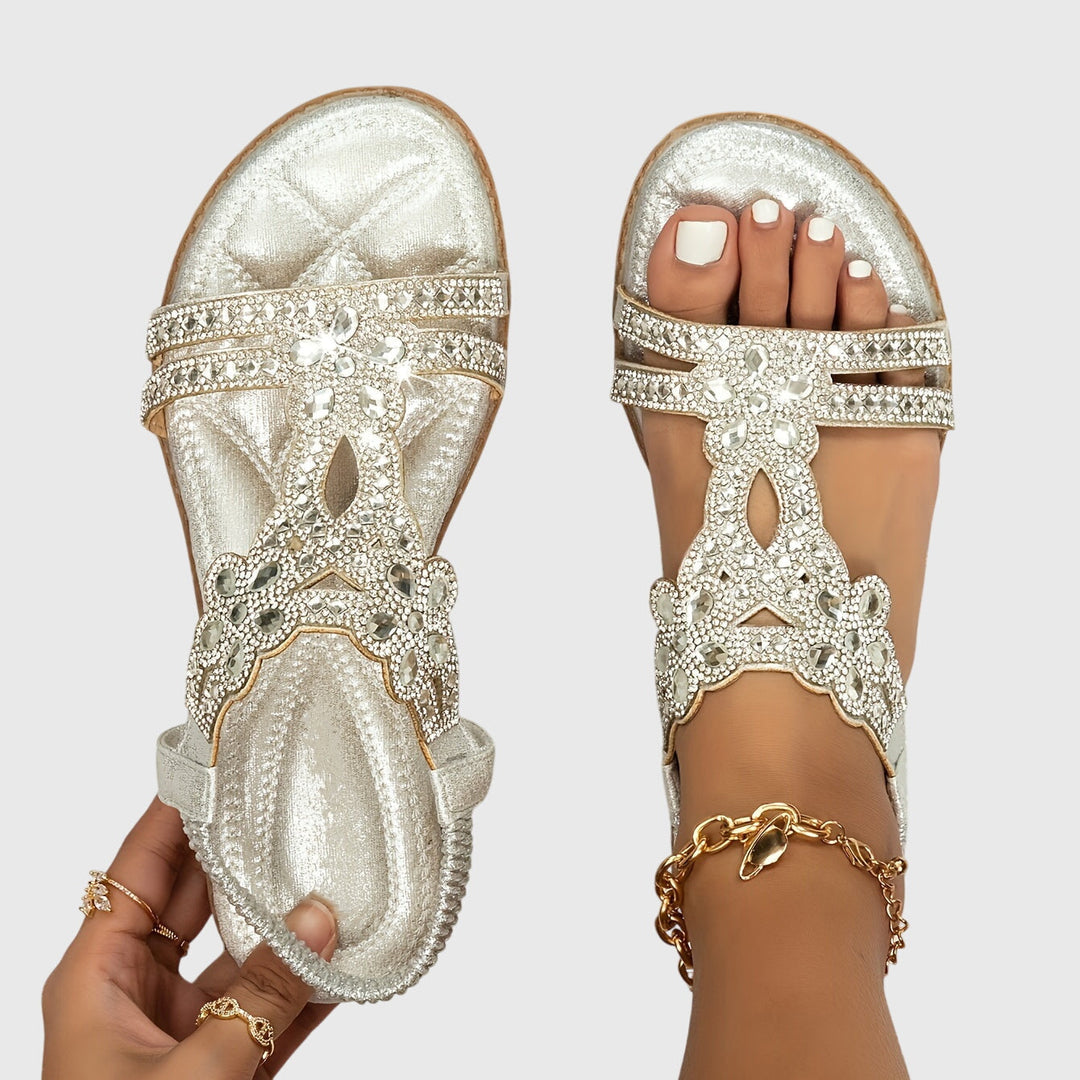 Embellished women's flat sandals, offering glamorous comfort for any occasion.