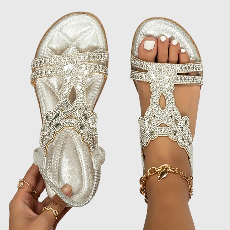 Women's comfortable flat sandals with elegant rhinestone details.