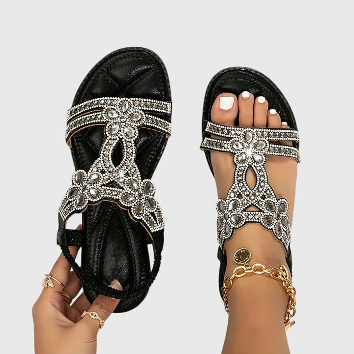 Rhinestone embellished women's sandals, a glamorous summer flat.