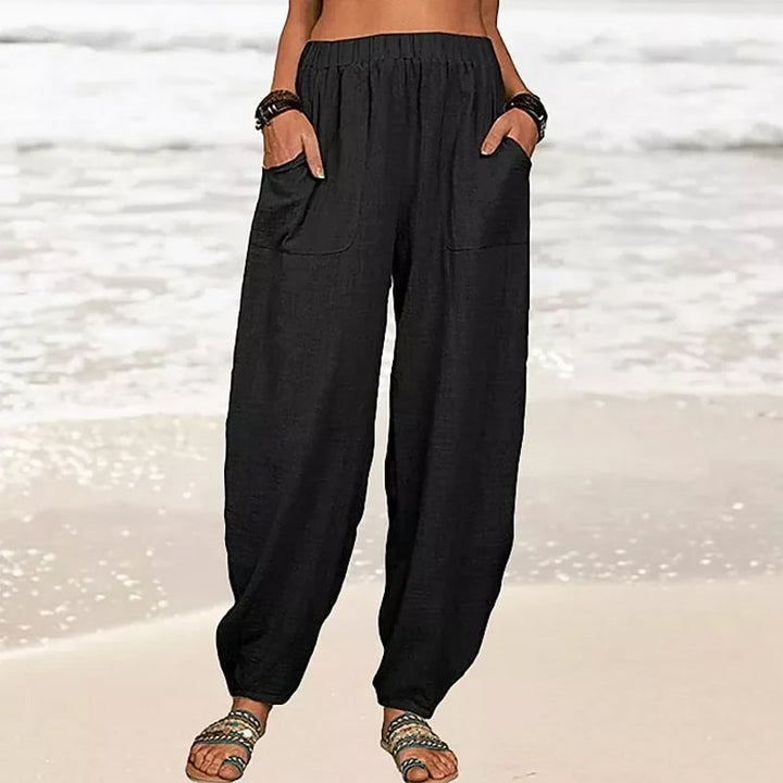 Comfortable Rizza women's beach pants on a seated model, highlighting relaxed fit and loungewear appeal.