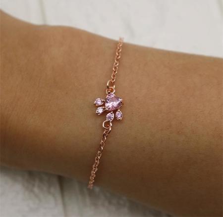 Elegant women's rose quartz bracelet with rose gold paw print, a beautiful accessory for cat lovers