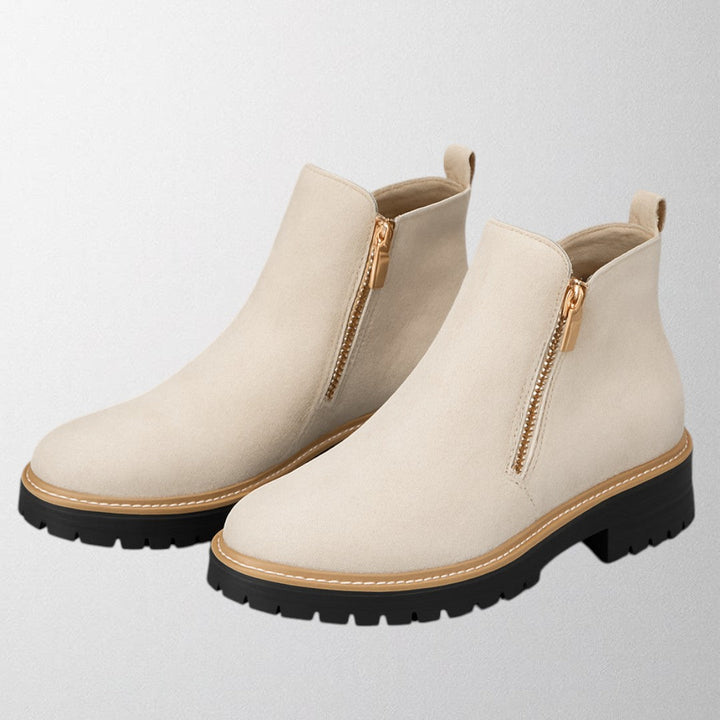 Easy-on women's versatile shoes with a round toe and side zip, combining comfort & sleek design.