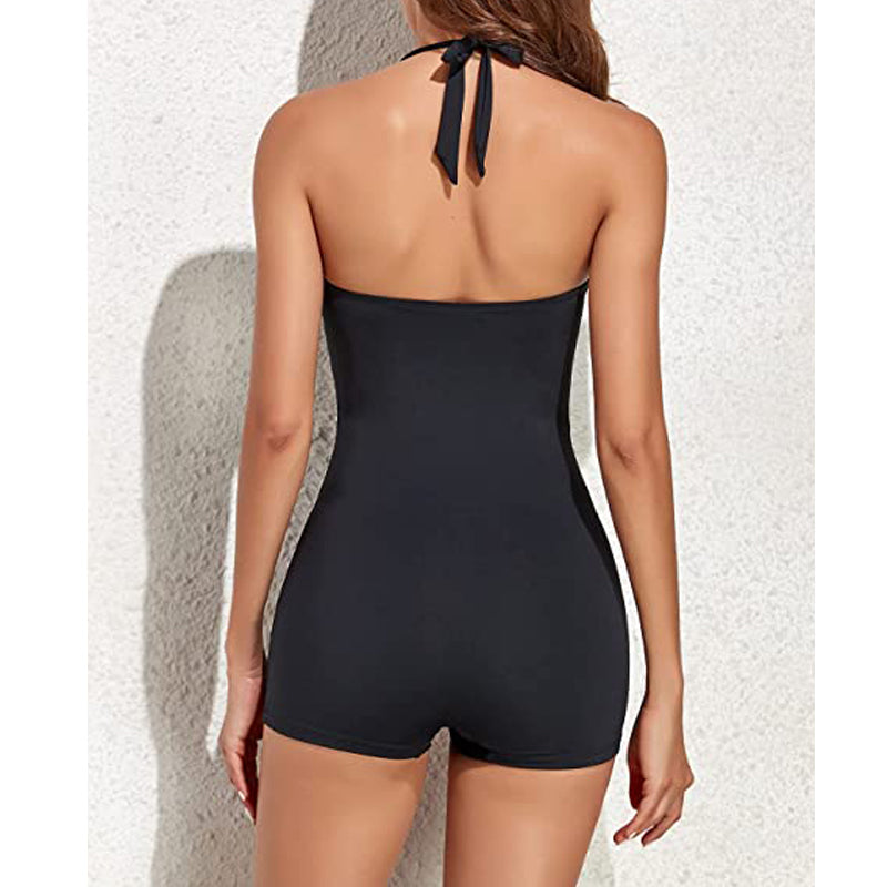 Side profile of women's one-piece swimsuit, showing ruched texture, halter top, and boyleg style.