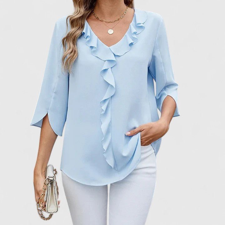 Feminine spring summer blouse with V-neck, delicate ruffles, and chic split sleeves.