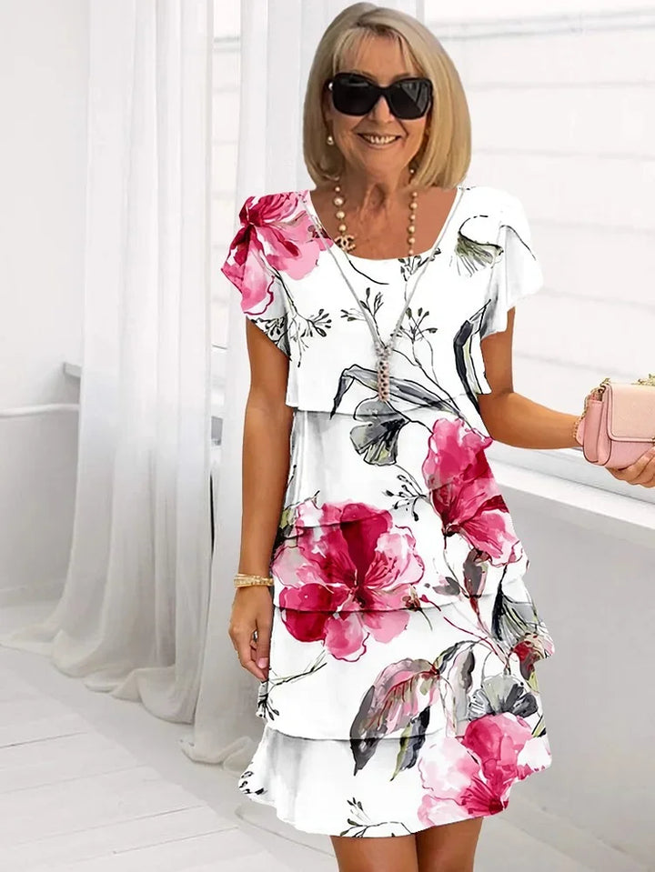 Women's ruffled floral print midi dress with delicate pleats and adjustable straps, perfect for summer elegance.