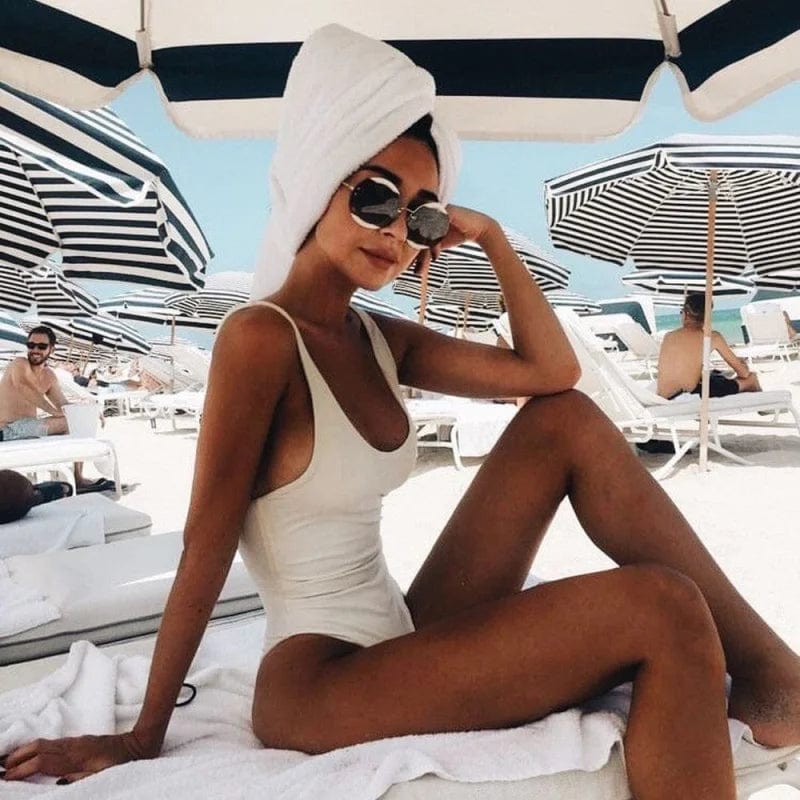 Classic women's one-piece swimwear with scoop neck & open back, perfect for pool days & comfort.