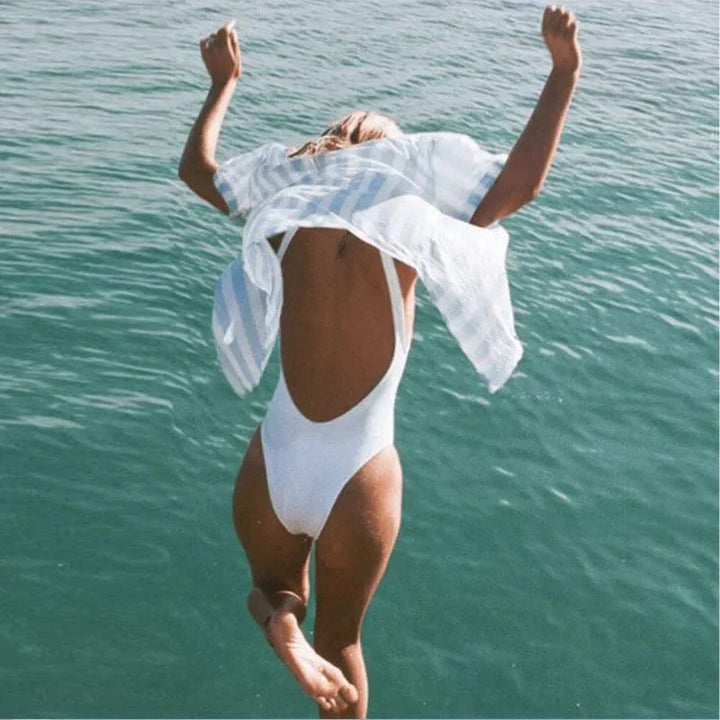 Effortless women's scoop neck open back one-piece for stylish beach fashion and swimming.