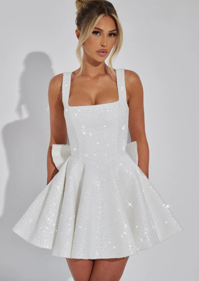Elegant sequined fit & flare party dress with a charming back bow, perfect for special occasions.