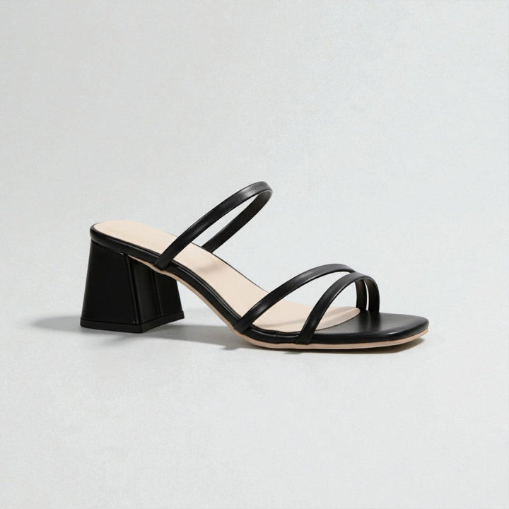 Comfortable women's slip-on sandals with a chunky block heel, perfect for minimalist summer fashion.