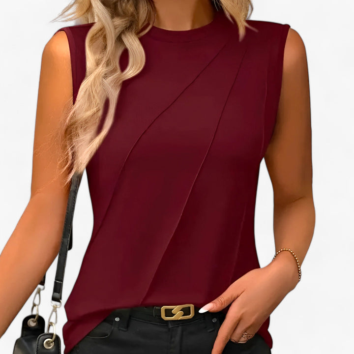 Smart casual women's sleeveless crew neck blouse. Chic diagonal pleats make it perfect as a layering top.