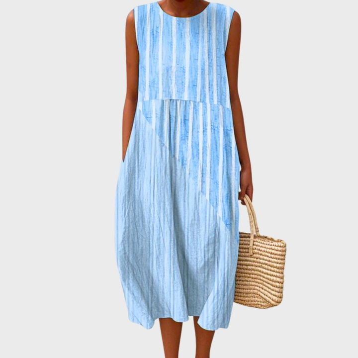 Comfortable women's sleeveless midi dress featuring a vibrant patchwork print, relaxed fit, and stylish bubble hem.