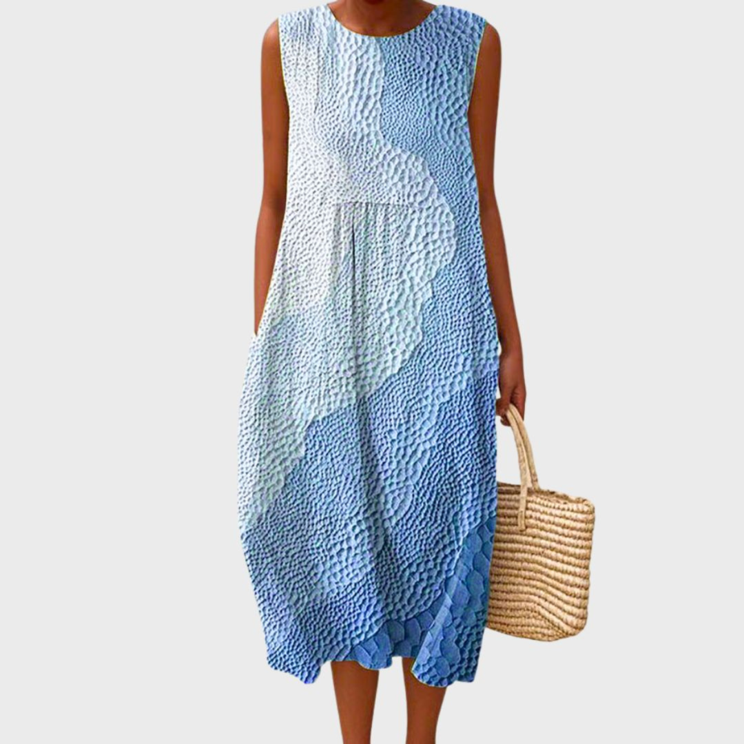 Flowy sleeveless midi dress for women, ideal for summer vacation. Features a unique patchwork print & bubble hem.