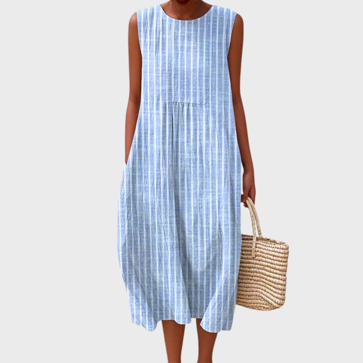 Artistic women's sleeveless midi dress with a colorful patchwork design, round neck, and relaxed bubble hem.