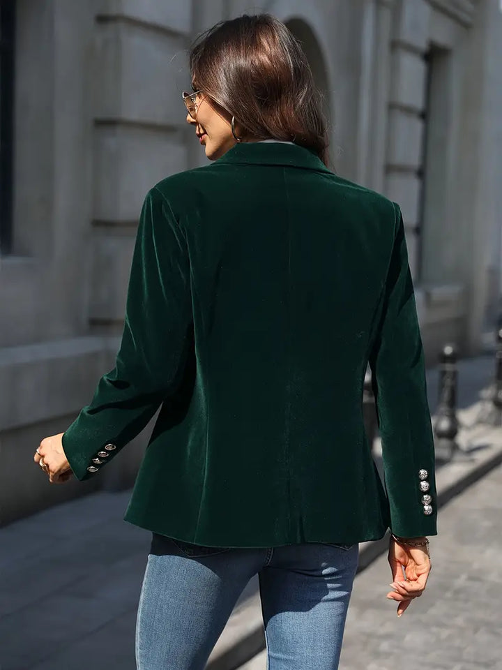 Elegant women's slim-fit blazer with a peak lapel and decorative gold buttons.