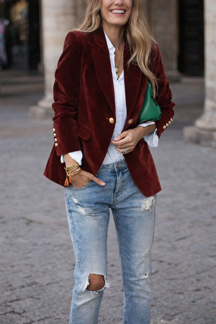 Women's elegant slim-fit blazer, peak lapel, adorned with polished gold buttons.