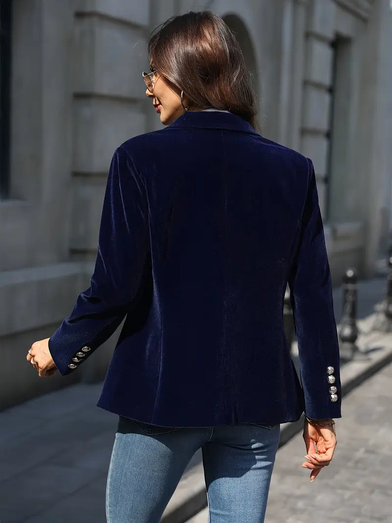 Contemporary women's blazer, peak lapel, slim fit, with prominent gold buttons.