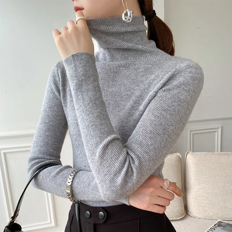 Classic women's slim fit turtleneck sweater in a fine knit, offering elegant style and versatile winter layering.